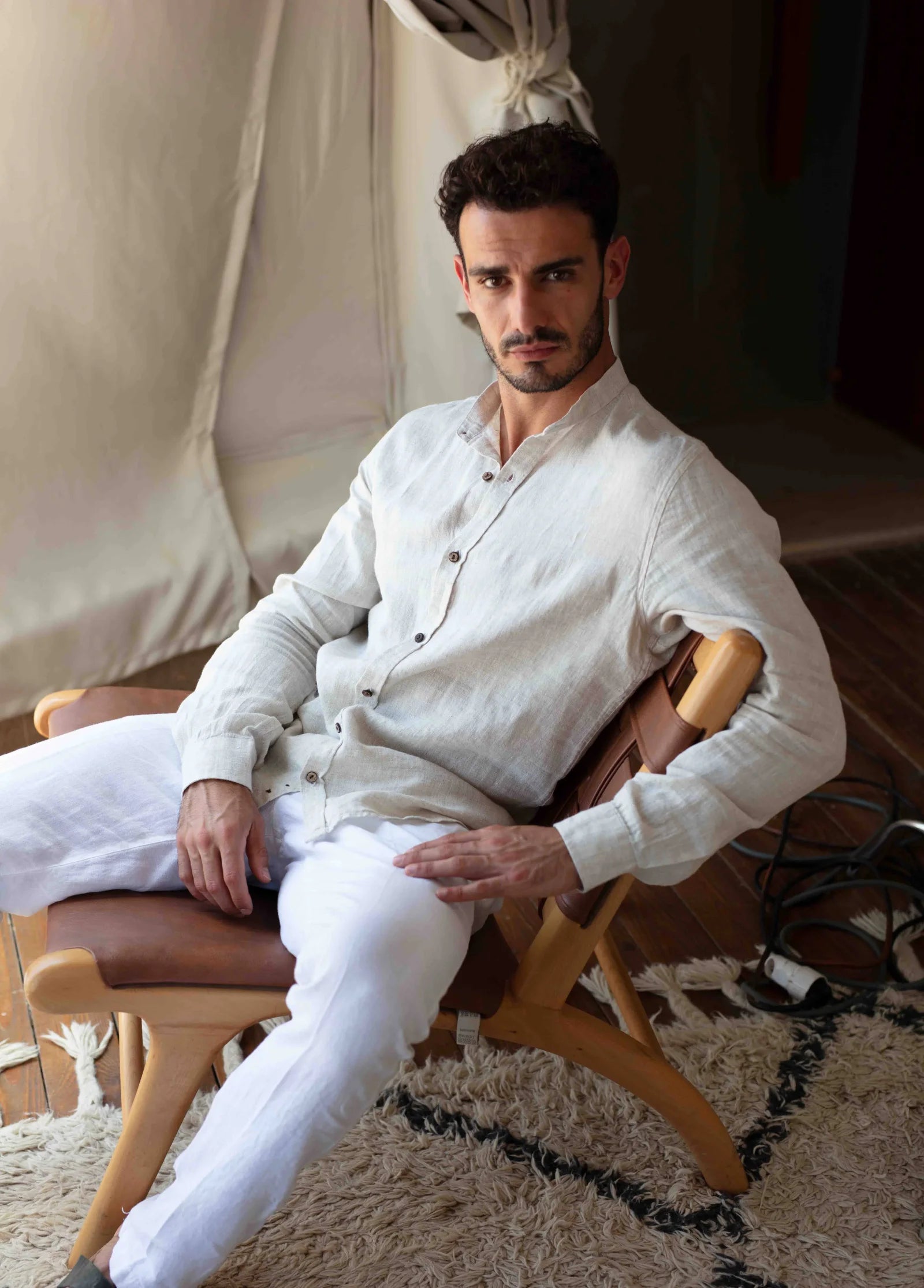 Man wearing a natural linen shirt in a softly lit room